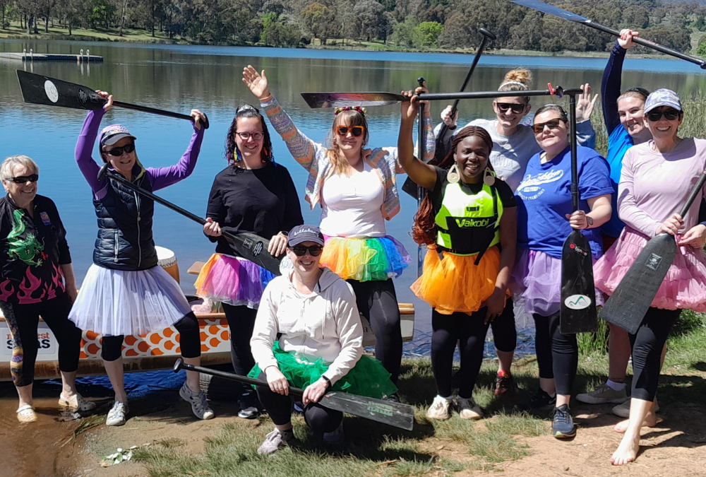 a group of people wearing tutus went to dragon boating