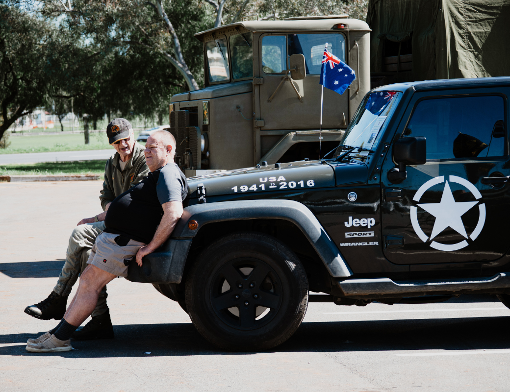 A car with Australian flag and two people